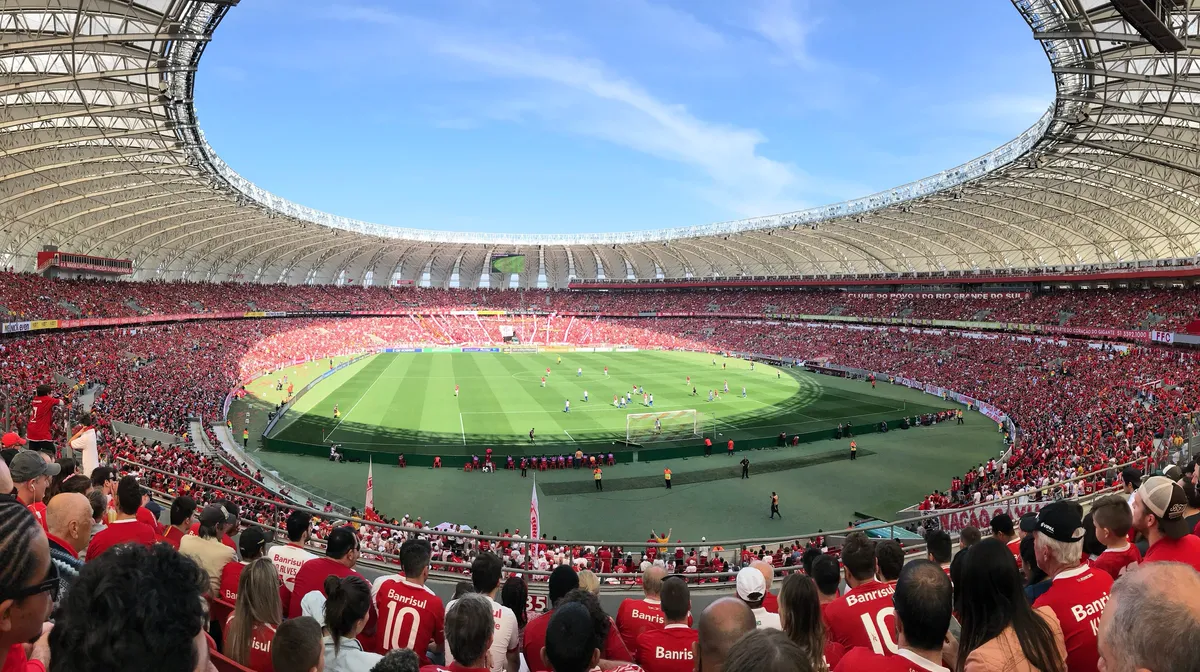 A packed football stadium seen from the stands